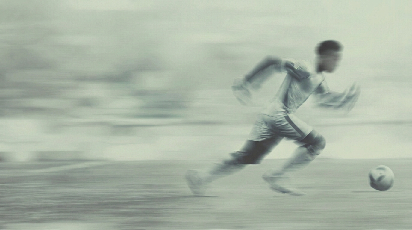 Footballer sprinting with the ball